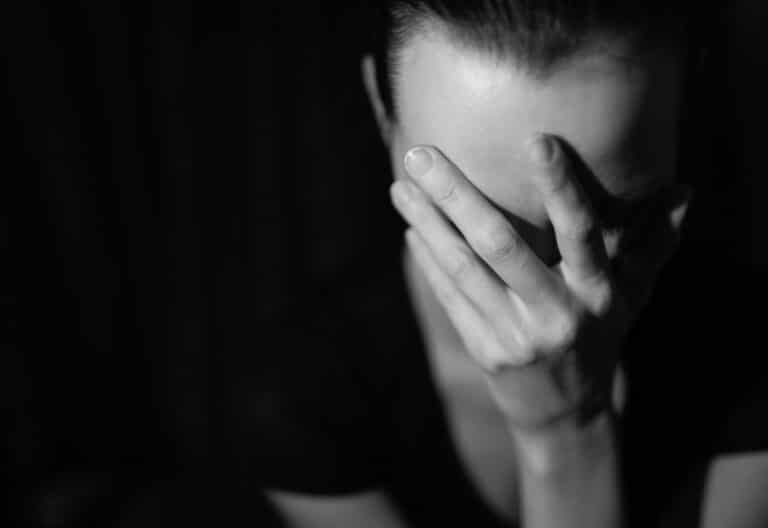 Depressed woman in dark setting