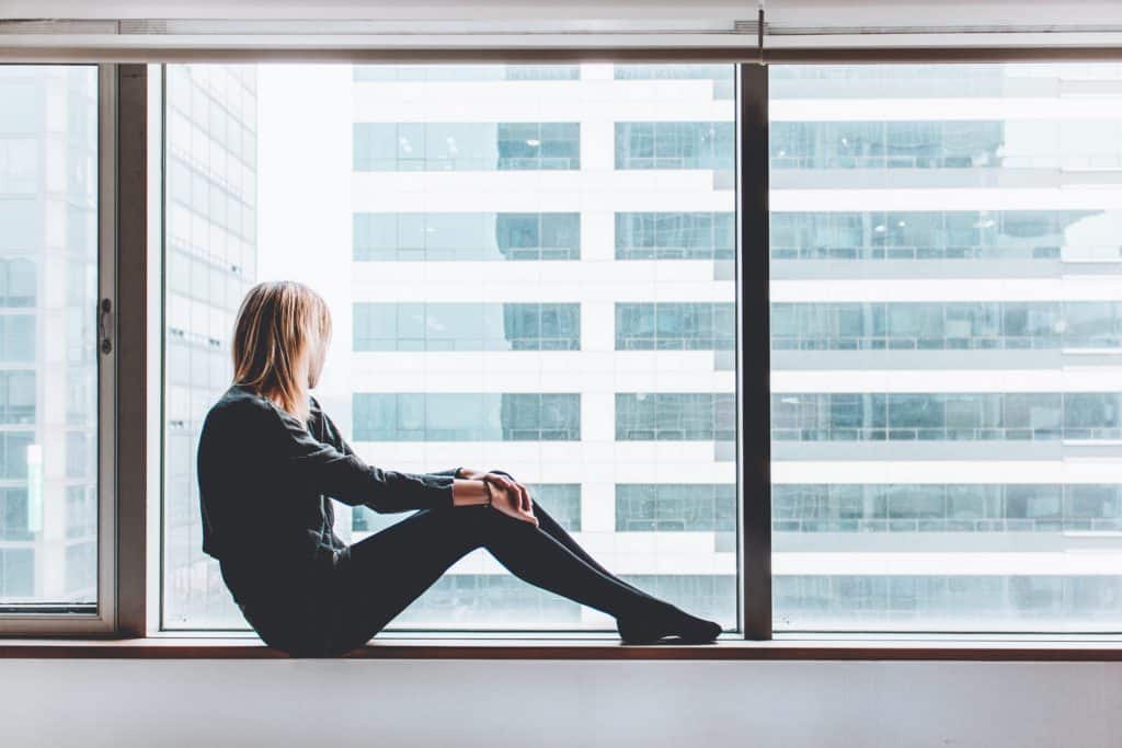 woman sitting in window