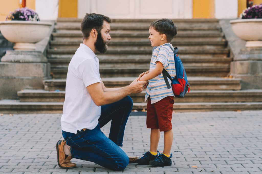 man holding child managing co-parenting in recovery