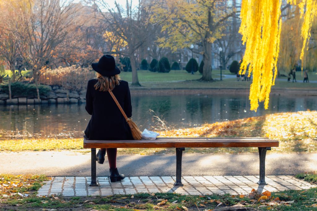 woman sitting by the lake