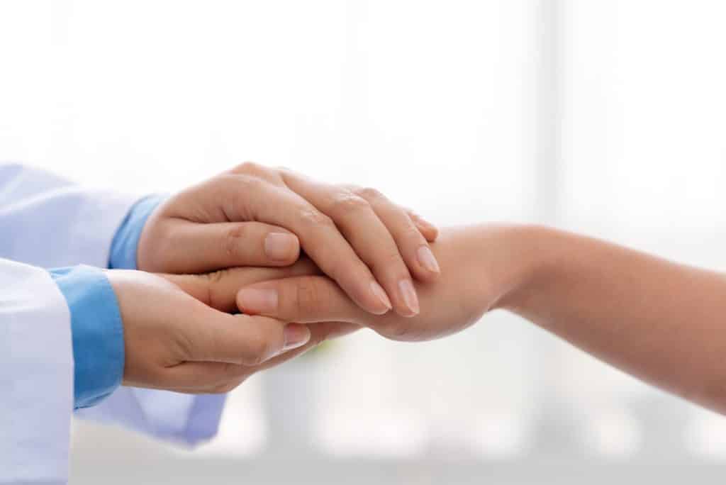 Doctor Holding Patient's Hand - What Is Relapse and Can It Be Prevented?