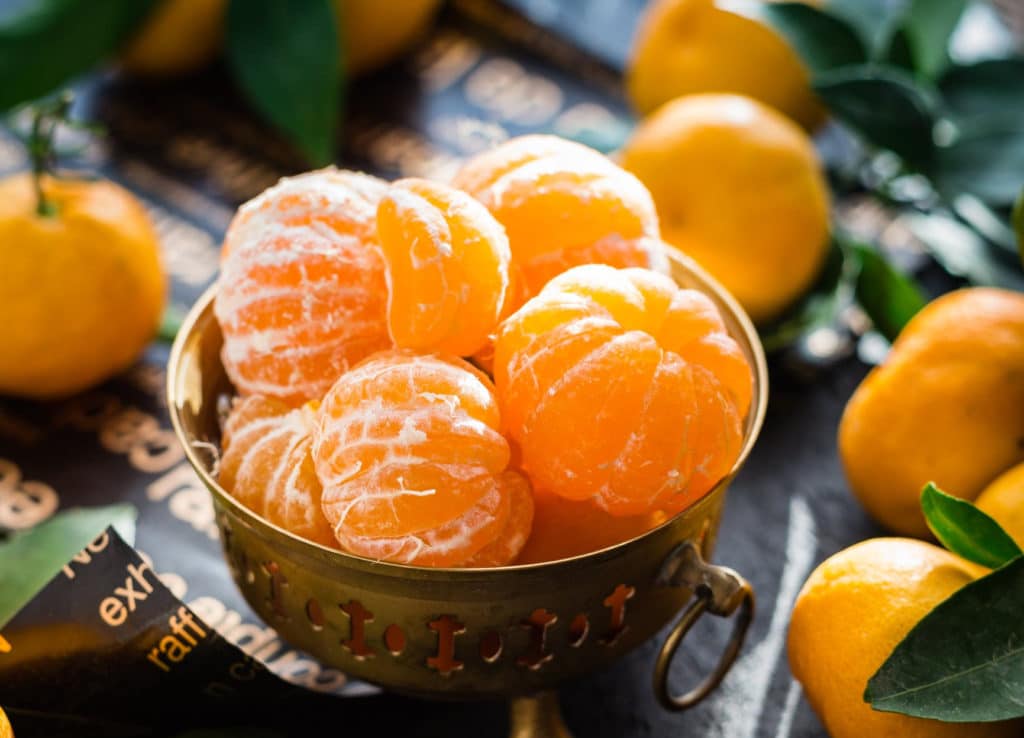 oranges in brass bowl